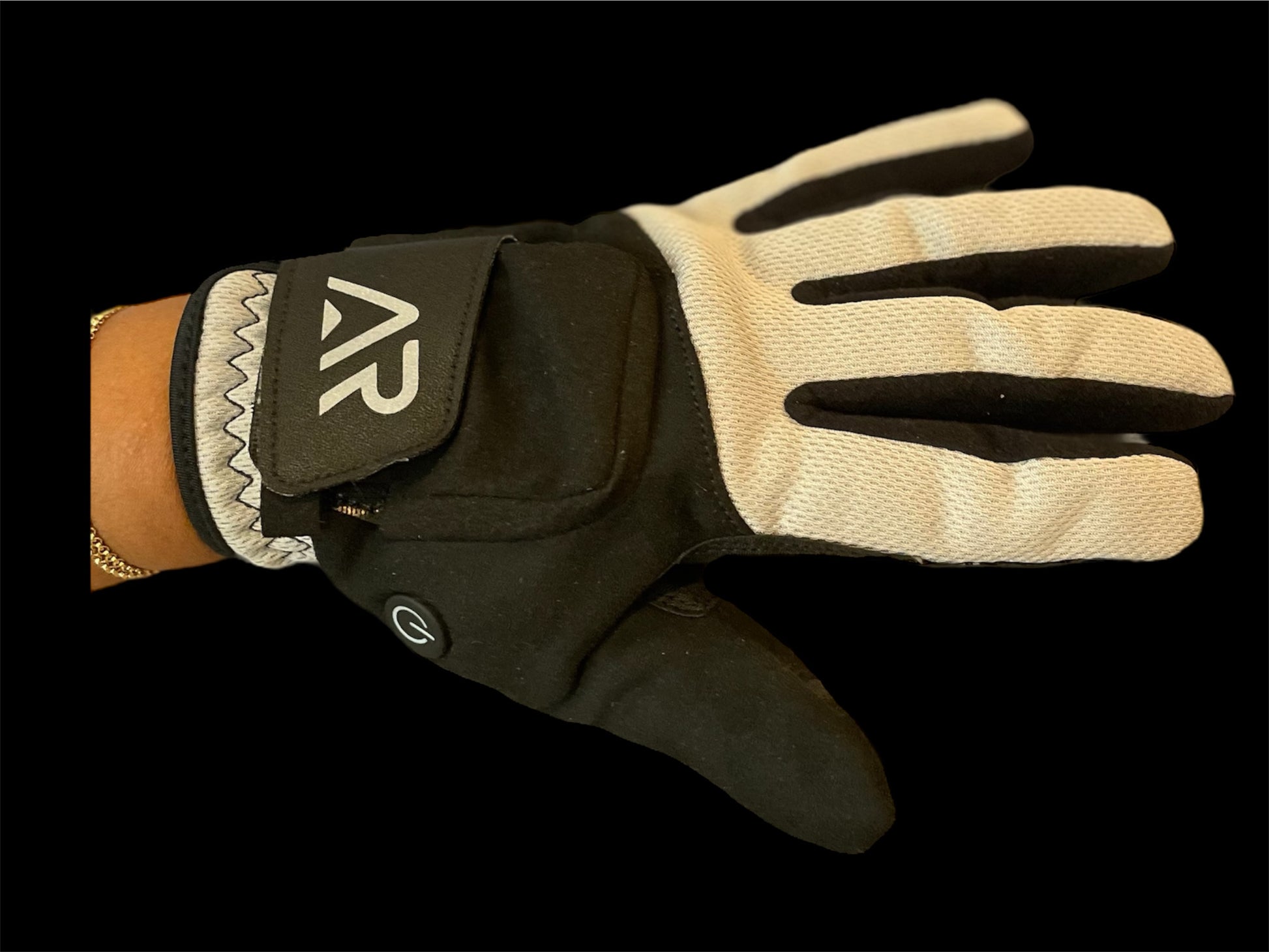 In the image, a hand is adorned with the Black & Gray GEN2 Heated Sports Glove by arcticreaction. This glove, featuring the letters AR on the wrist, is set against a solid black background. It has a power button symbol on the thumb area and provides dual heat settings for optimal warmth.